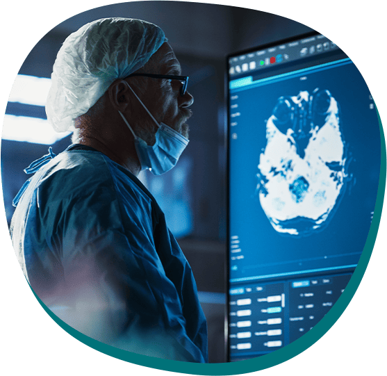 A medical expert in surgical scrubs studies a brain scan, representing our CRO's extensive network of top oncologists and their expertise in complex clinical trials.